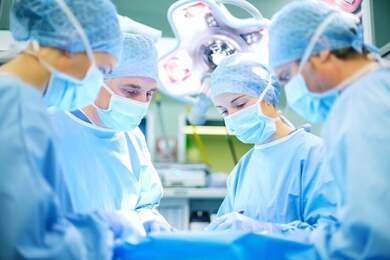 image of surgeons working in an operating room in a hospital